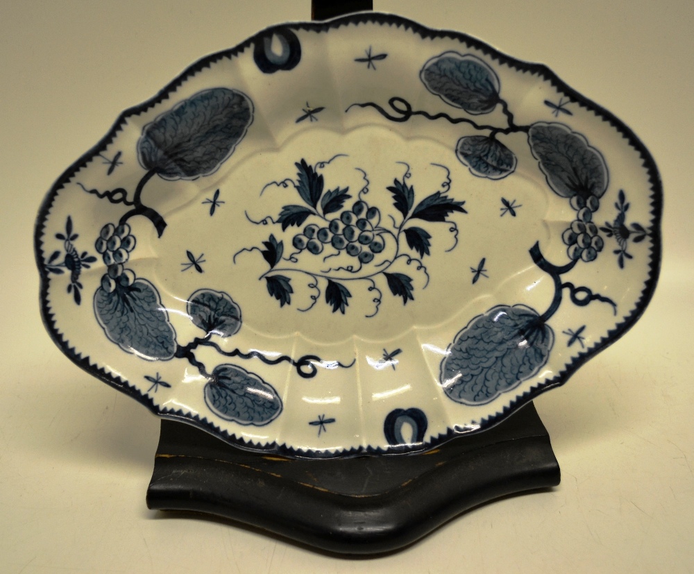 An oval mid eighteenth century bow porcelain blue and white dish, with grapes to the centre and