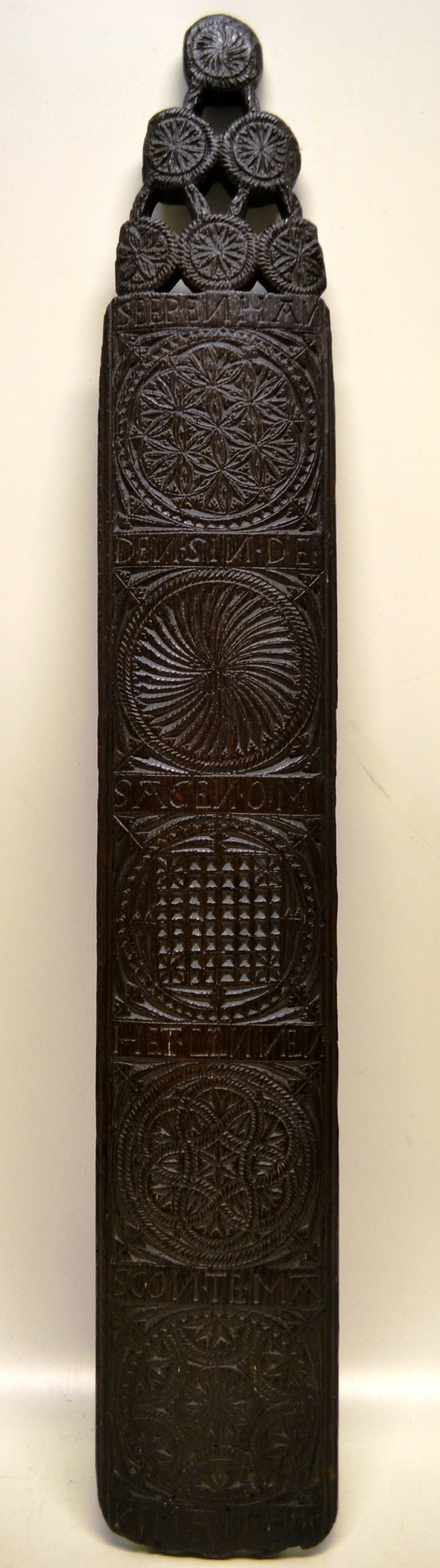 An early eighteenth century Friesland oak mangling board, with incised pattern and text and dated