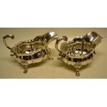 A large pair of early Victorian silver sauceboats, the everted panelled oval bodies engraved a