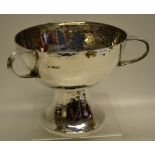A George V silver hammered tyg, the bowl with 3 scroll handles on a pedestal circular foot. 6.