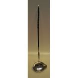 A George III silver punch ladle, with a side lip to the oval bowl, a whale bone twist handle, the