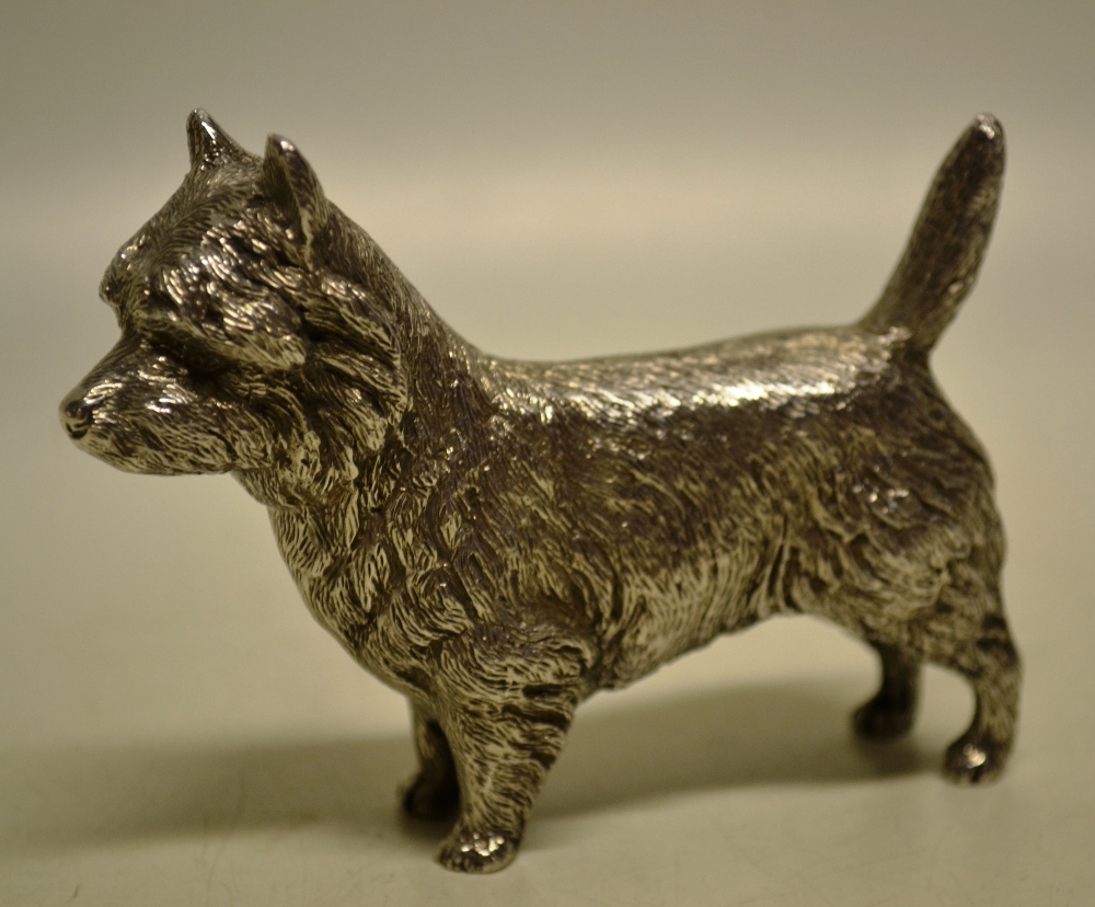 A cast silver medal of a Norfolk terrier. 4in (10cm). Maker Edward Barnard and Sons, London 1974.