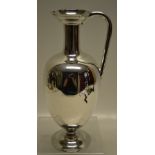 A Victorian silver claret jug, the inverted vase shape body with a slim neck and flared spout with