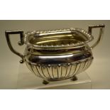 An Edwardian silver rectangular basin, part ribbed and fluted with a gadroon and leaf petal corner
