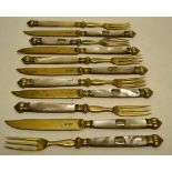A set of six pairs of early nineteenth century continental silver gilt dessert eaters, the knife
