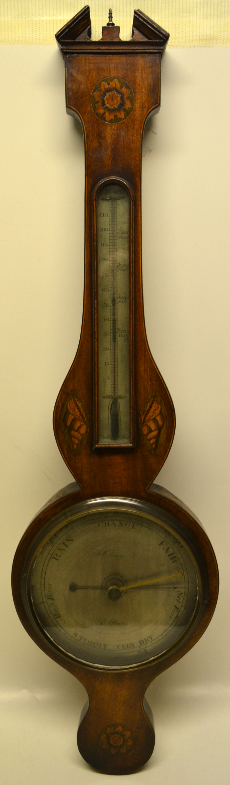 An early nineteenth century mahogany veneered banjo shape wheel barometer, having a broken arch