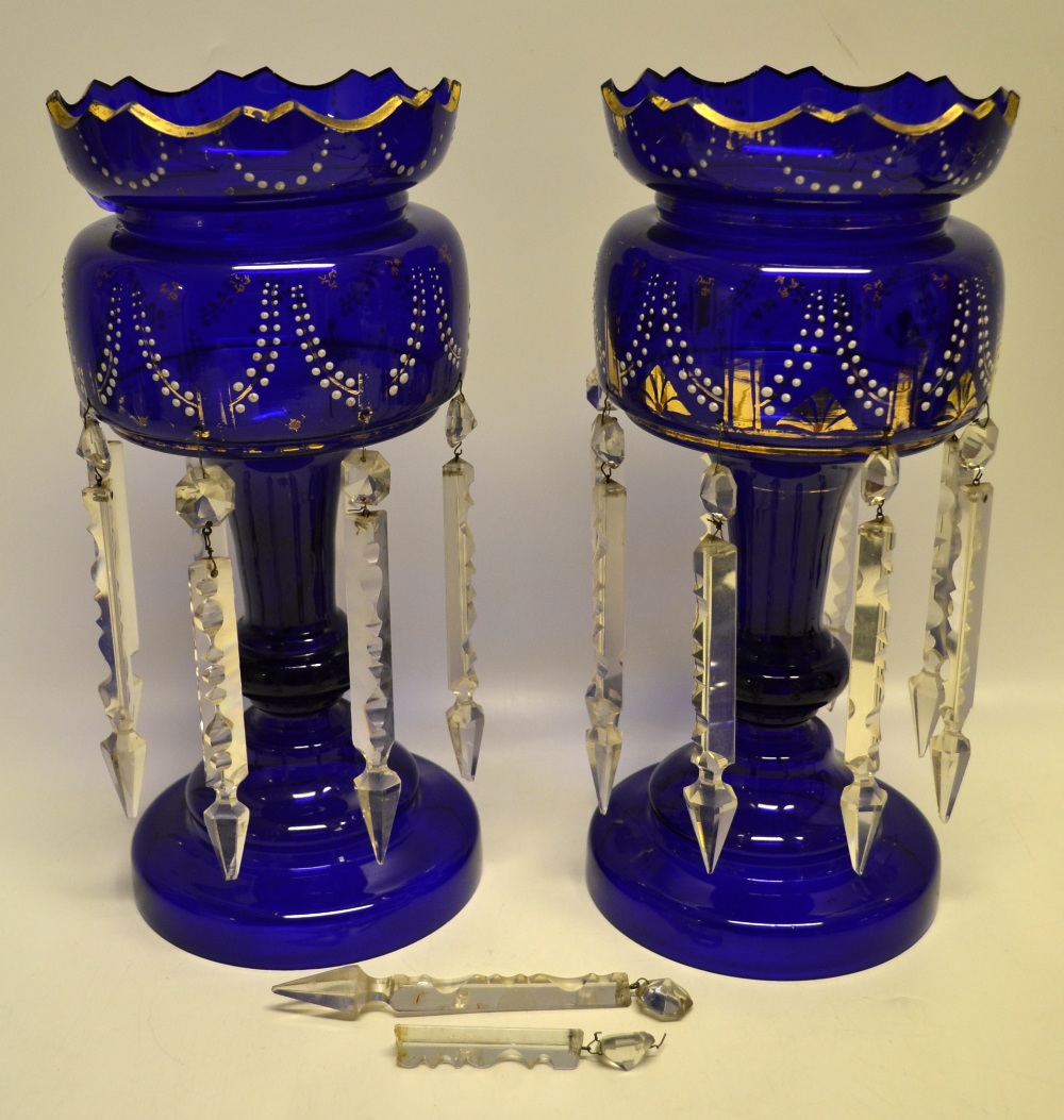 A pair of nineteenth century large Royal blue glass mantlepiece vases, with white beaded jewelling