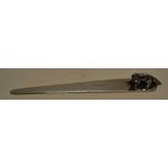 A silver tapering paper knife with a cast fox to the handle. 7.25in (18.5cm). Importer and Retailer,