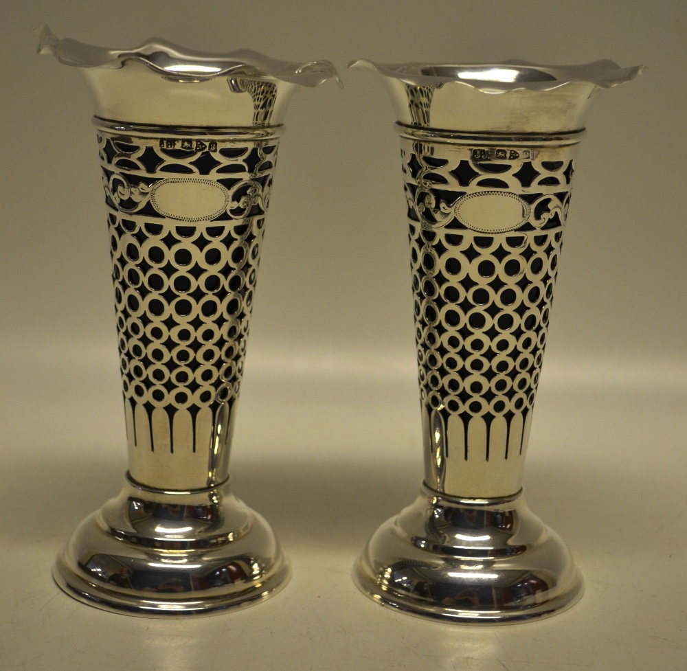 A pair of silver late Victorian flower vases, with blue glass liners (slight chipping) and pierced