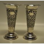 A pair of silver late Victorian flower vases, with blue glass liners (slight chipping) and pierced