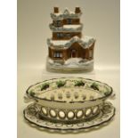 A Worcester cream ware oval dessert basket and stand, with green and brown berried foliage border to