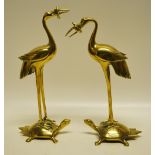 A pair of late nineteenth century oriental brass cranes standing on a tortoise . 9.25in (25cm) and