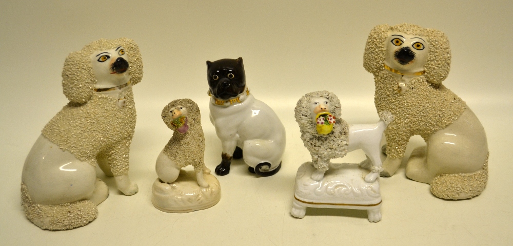 A pair of late nineteenth century Staffordshire poodles, 6in (15cm) and two earlier Staffordshire