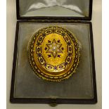 A Victorian oval gold locket the front with hinged open inset seed pearl star and blue enamel