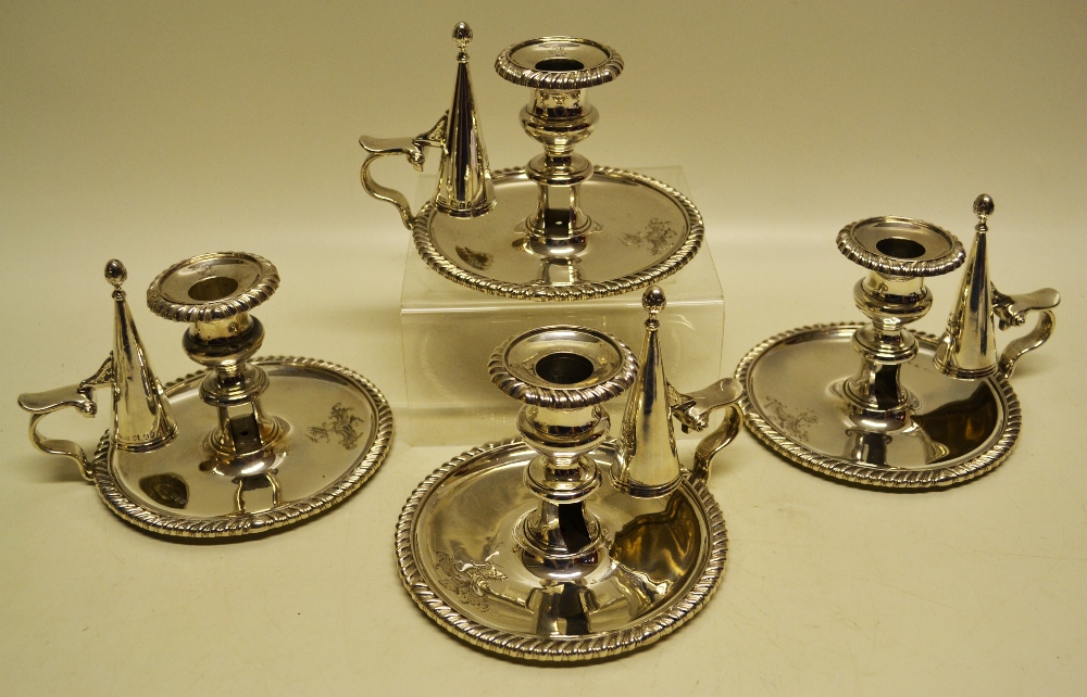 A set of four George IV silver bedroom candlesticks, the circular bases and detachable nozzles