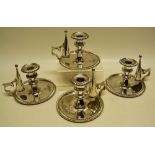 A set of four George IV silver bedroom candlesticks, the circular bases and detachable nozzles