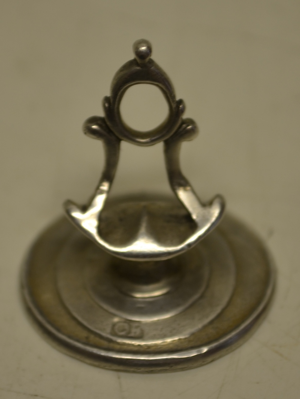 A George III silver oval seal, with an angled pierced thumb piece handle, the matrix with intaglio