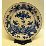A Continental tinglaze blue and white floral decorated dish. 13.75in (35cm). Nineteenth century. (