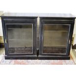 A pair of nineteenth century aesthetic ebonized pier cabinets, with a reeded frieze and a glazed