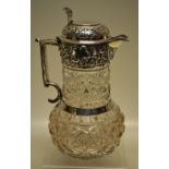 A George V cut and moulded glass claret jug, the silver mounted neck with repouse scrolls and beaded