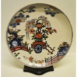 A Japanese mid nineteenth century porcelain charger, with blue and white underglaze and coloured