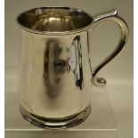 A George II silver pint mug, with a capped scroll handle, on a moulded spreading foot. Maker Francis