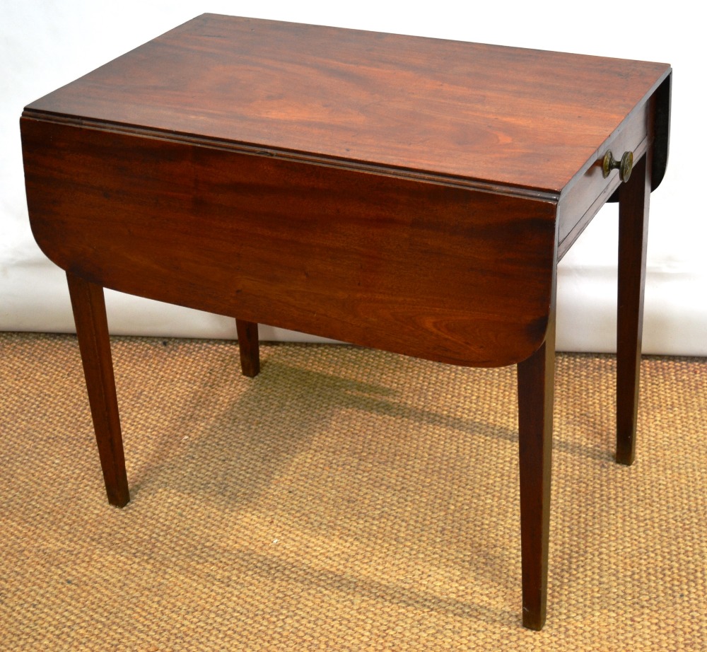 A Regency mahogany Pembroke table, the rectangular drop leaf top with rounded corners, a drawer