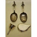 Two continental late nineteenth century silver spice spoons, decorated figures in old style dress,