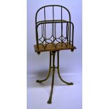 A late Victorian brass magazine stand, the divisions with vertical rails with hooped stretchers to