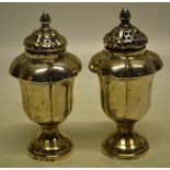 A pair of mid nineteenth century Indian colonial silver pepper casters, melon panelled vase