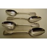 A set of four George IV silver fiddle pattern table spoons, engraved a crest of a serpent entwined