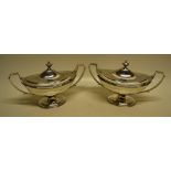 A pair of George III silver oval sauce tureens, with bracket loop handles and reeded borders, the