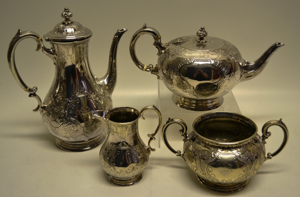 A Victorian electroplated four piece tea and coffee service, engraved foliage shell scrolls and a