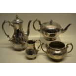 A Victorian electroplated four piece tea and coffee service, engraved foliage shell scrolls and a
