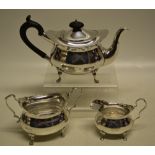 A small Edwardian three piece tea service, the avoid ogee bodies engraved initials and an