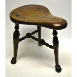 A late nineteenth century lacemakers stool, the saddle shape oak seat on turned fruitwood legs