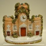 A Staffordshire porcelain nineteenth century gatehouse spill holder, with a clock tower. 5.5in (
