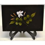 A nineteenth century black marble plaque with a pietra dure flower panel. 6in (15cm) x 4in (10cm).
