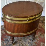 A Regency mahogany brass bound oval wine cooler, having chased brass ring carrying handles, the