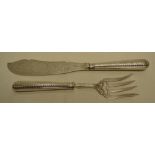 A pair of Victorian silver fish servers, with an engraved blade and tines and loaded engraved beaded