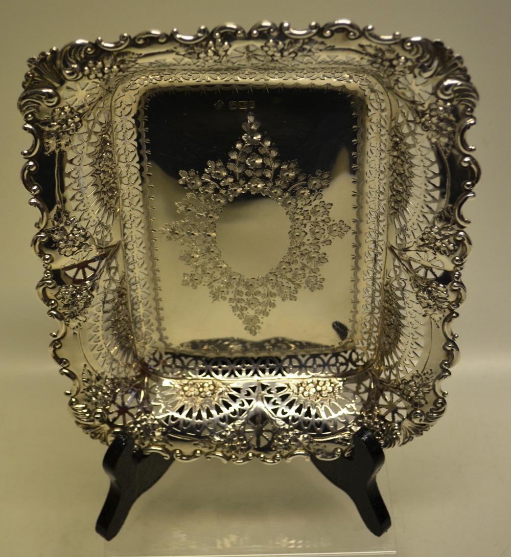 A late Victorian silver rectangular dish, with engraved oval vacant foliage cartouche, pierced