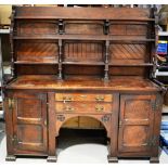 A Victorian oak dresser in the Gothic Revival style of Charles Eastlake, the open plate shelves with