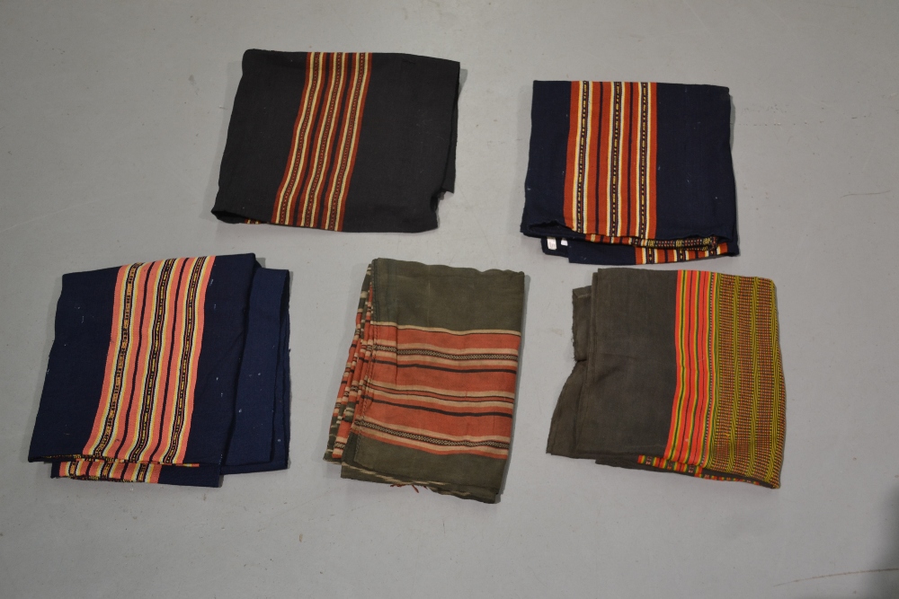 Four Laos women’s skirts, all woven with traditional colourful bands; two black cotton(?) and two