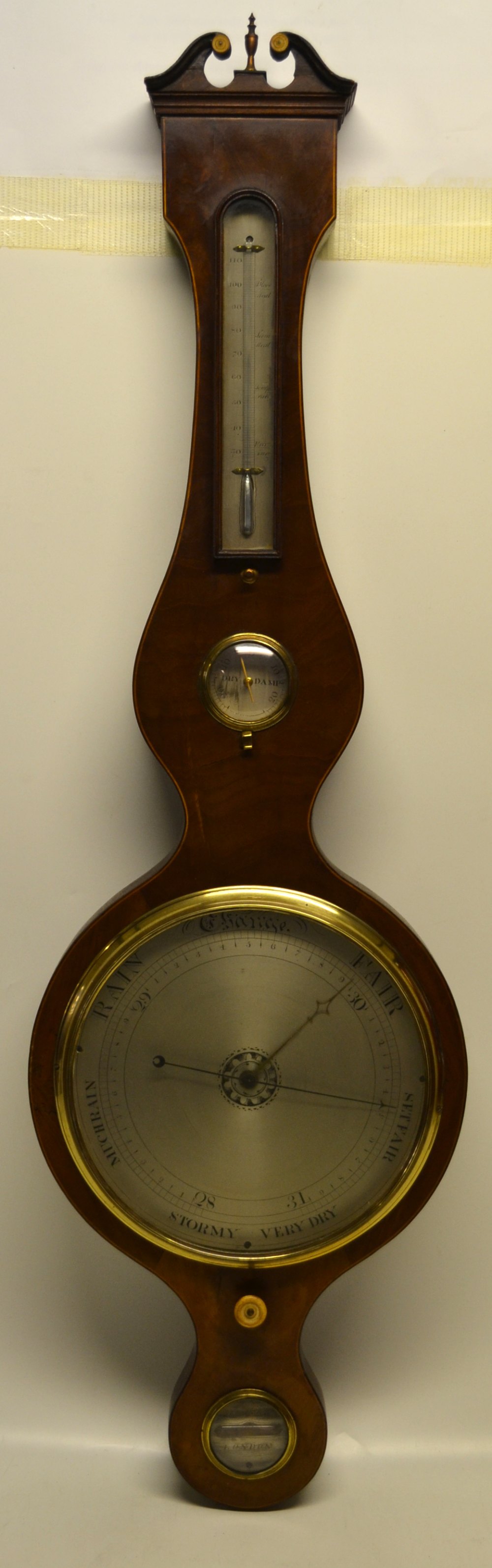 Somalvico, London. A Regency mahogany veneered banjo shape wheel barometer, the swan neck pediment