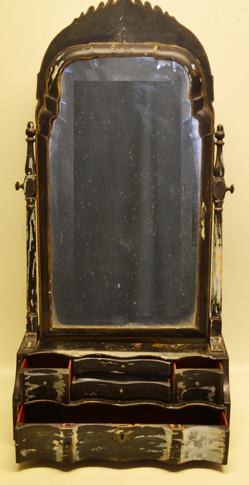 A Queen Anne style black lacquer decorated swing toilet mirror, the bevelled glass with a fret