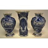 A pair of mid nineteenth century Dutch Delft blue and white vases depicting a man fishing in a