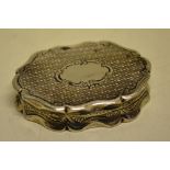 A Victorian silver oval vinaigrette, engine turned, the hinged cover with a vacant cartouche,