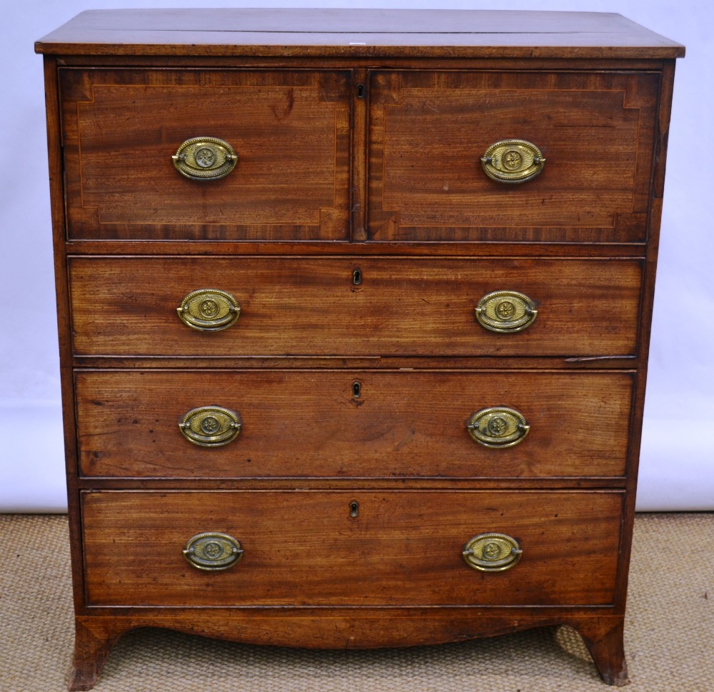 A Regency faded mahogany secretaire, the top cross banded inlaid stringing to the border and to