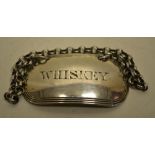 A George IV silver oblong WHISKEY (Irish) spirit label with a reeded edge and a chain. Maker