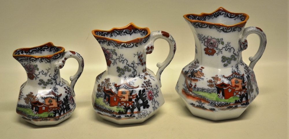 A graduated set of three early Victorian octagonal Mason's Ironstone China jugs, coloured painted